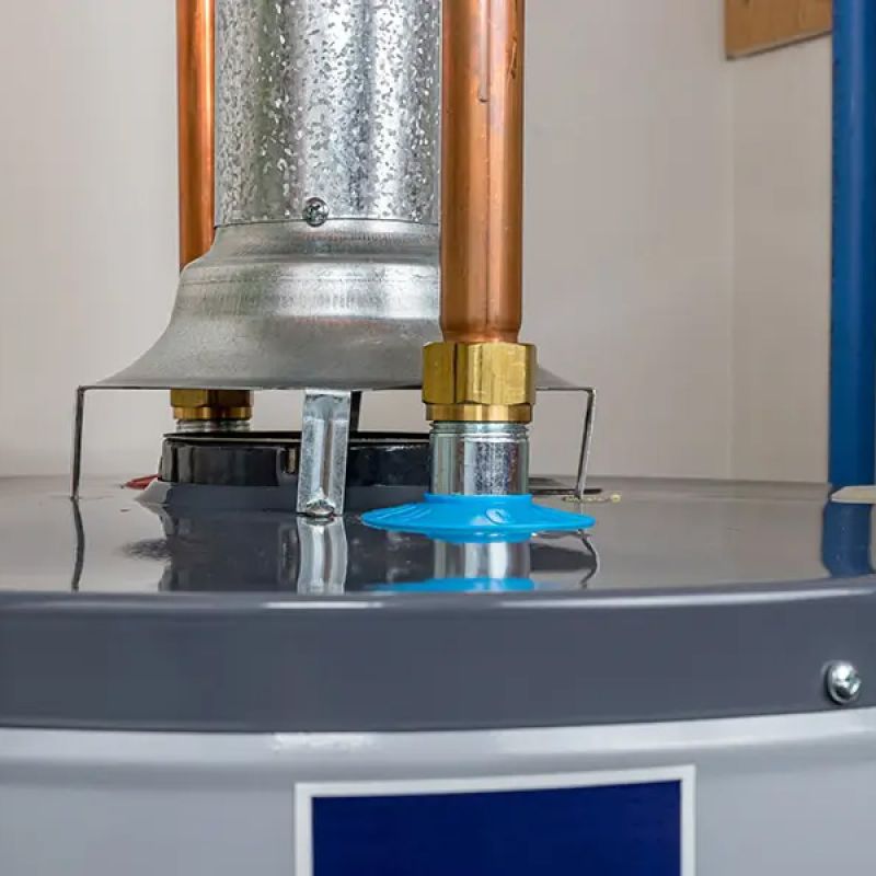 Close-up of modern water heater with copper pipes and metal vent in utility room.
