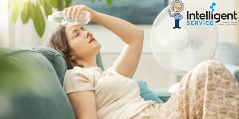 Woman cooling down with water bottle and fan in summer heat. Intelligent Service logo in the background.